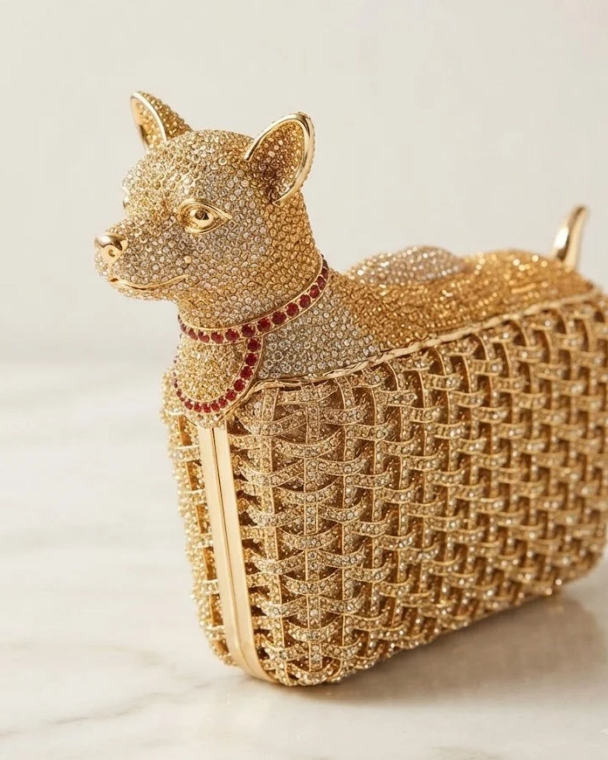 Gold dog-shaped crystal clutch with red gem collar, rhinestone lattice