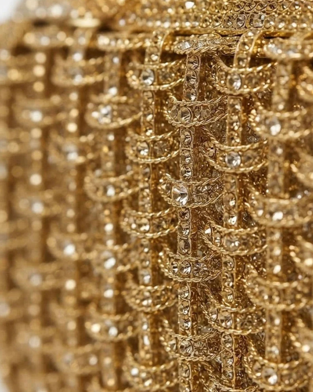 Close-up of gold rhinestone lattice on dog-shaped clutch