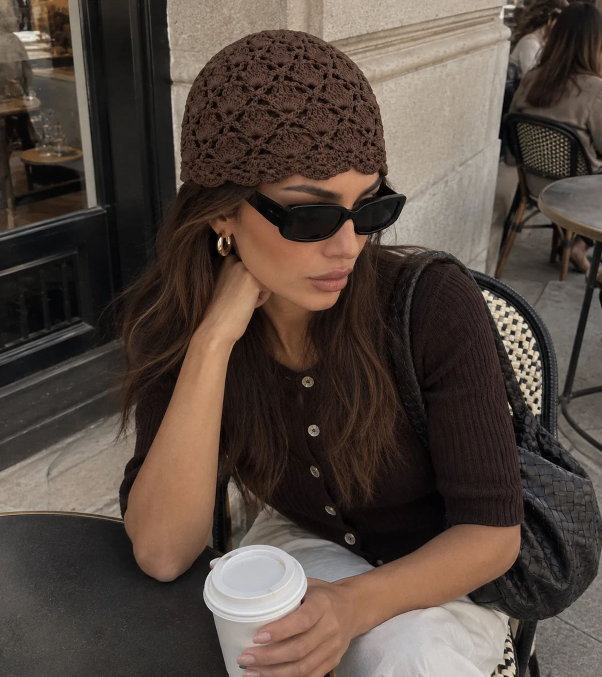 Dark brown floral lace crochet beanie hat on model, snug knit fit
