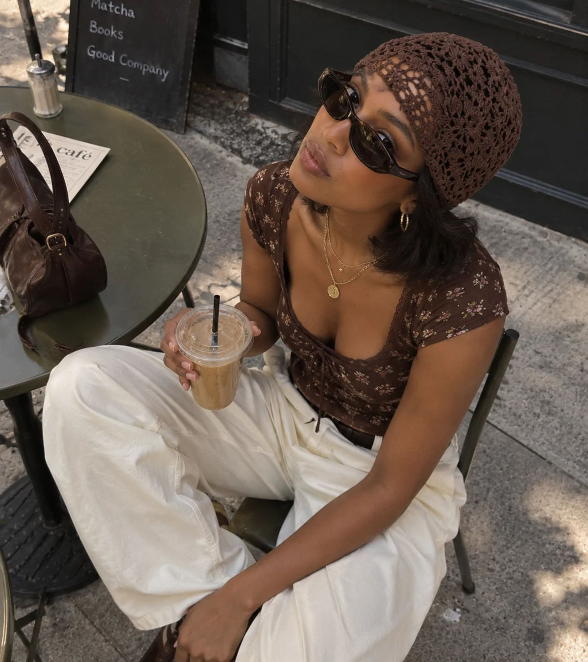 Dark brown crochet beanie hat with openwork floral lace pattern and slouch fit