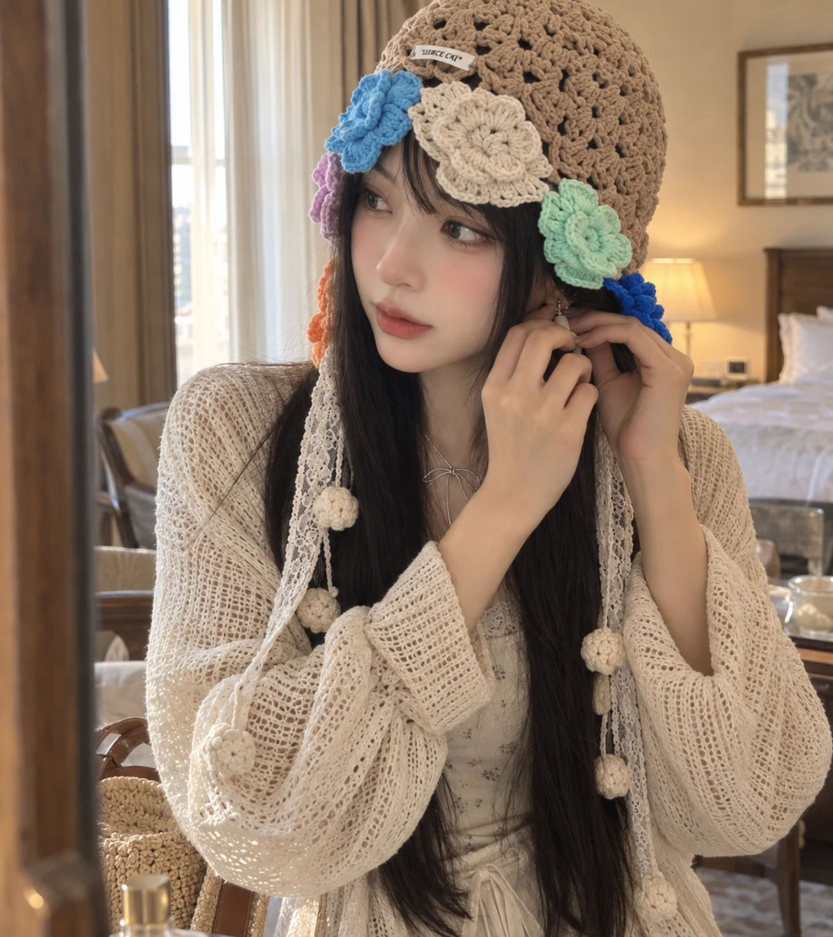 Crochet bonnet in tan with multicolor flowers and long lace ribbons with pom pom ends