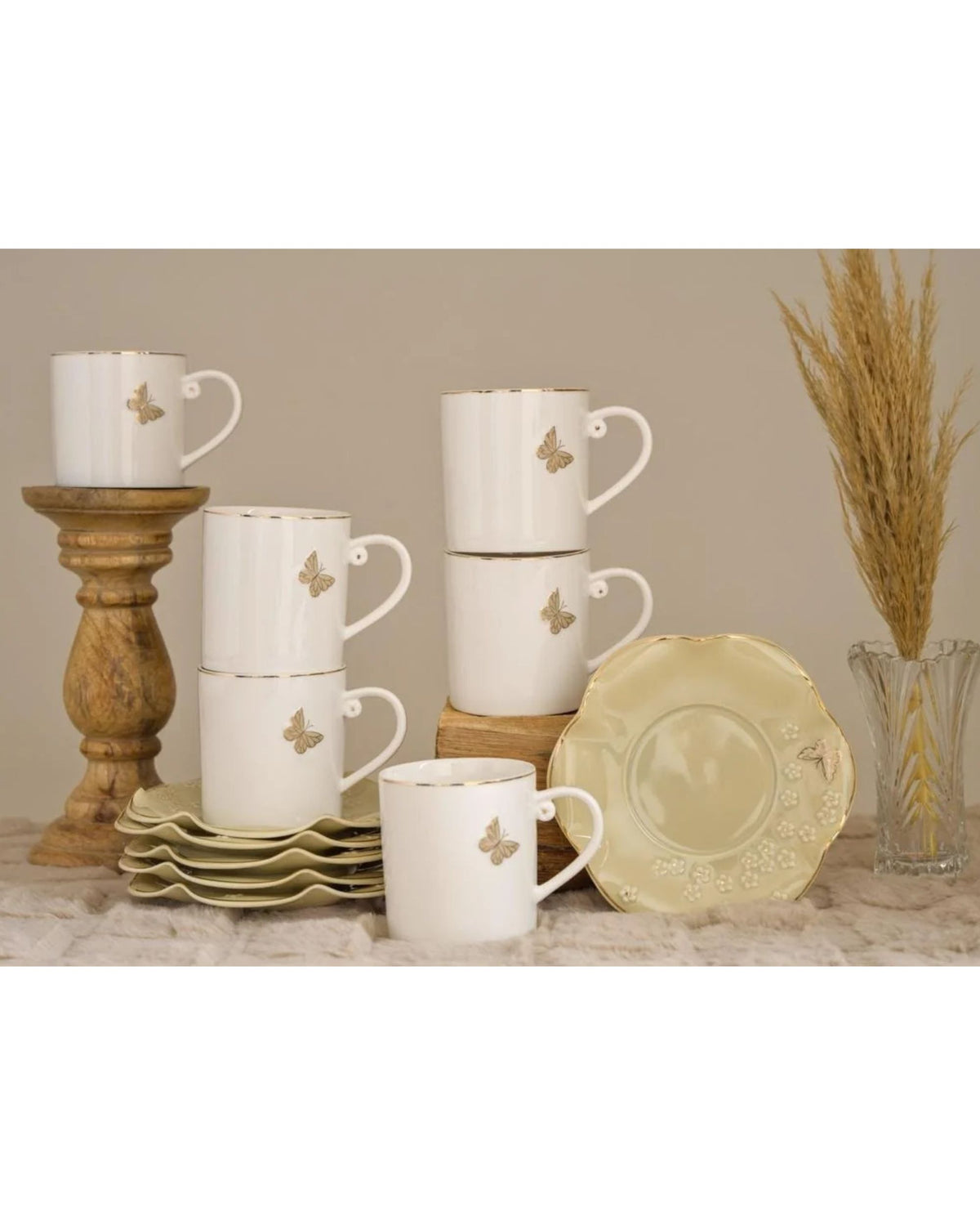 White butterfly mugs and gold-toned saucer, shown with stacked cups