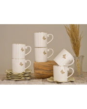 White coffee mugs with gold butterfly designs and matching saucers