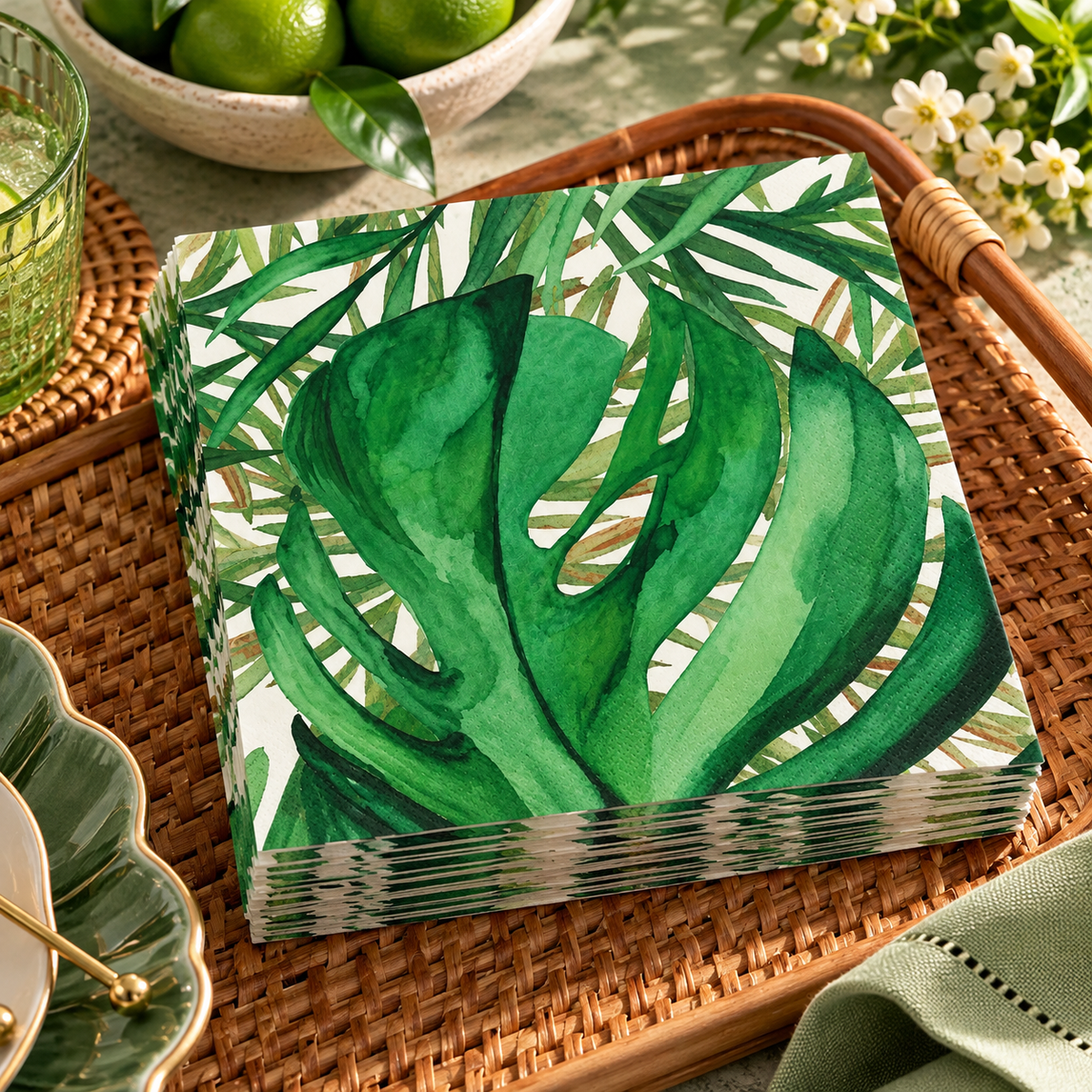 Stack of green tropical leaf print tissue paper napkins