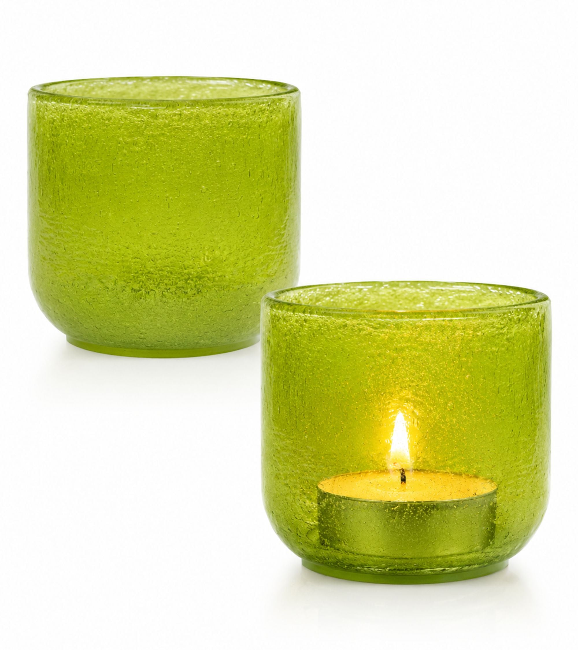 Green glass votive candle holder with lit tealight in textured cup