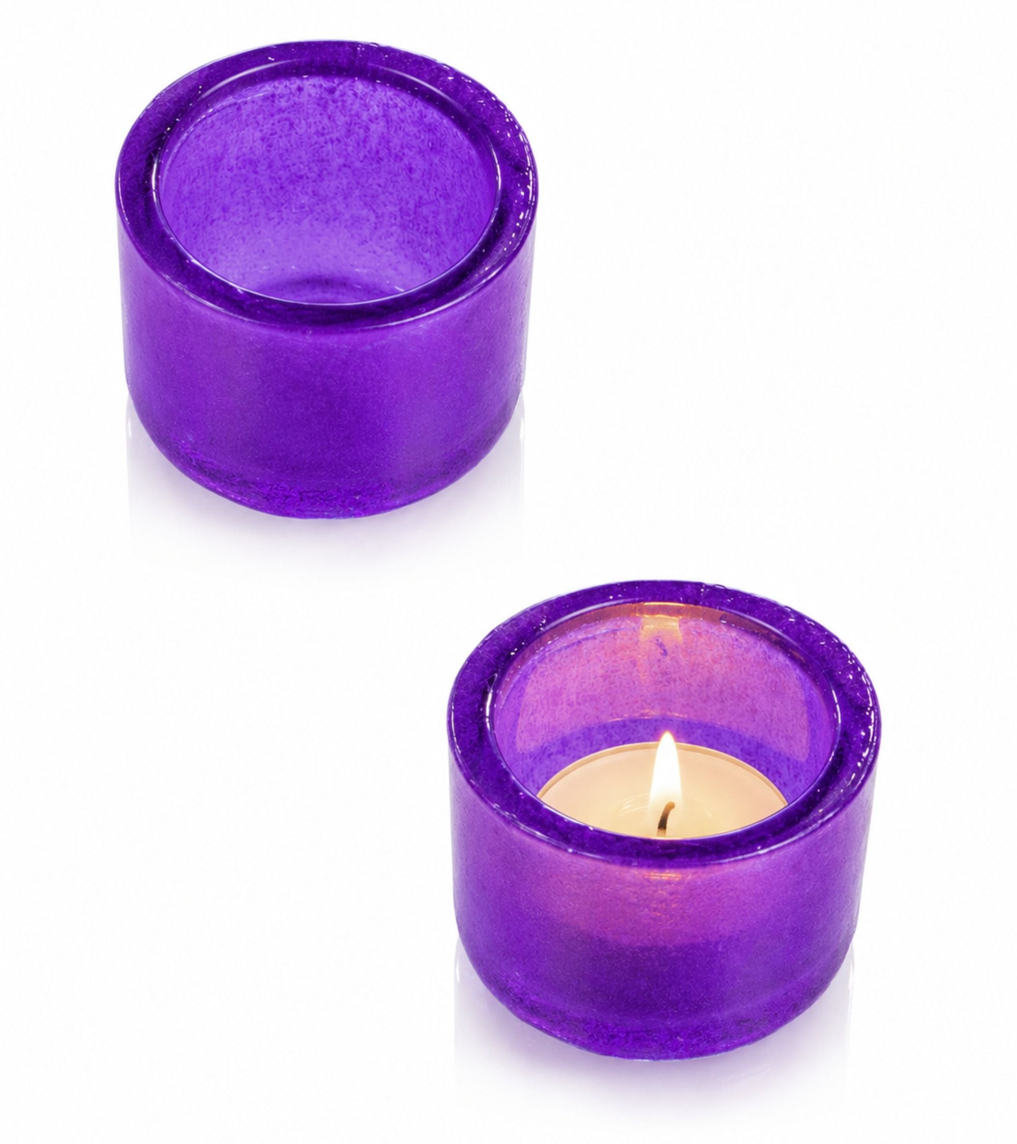 Two purple glass votive candle holders with one lit tealight