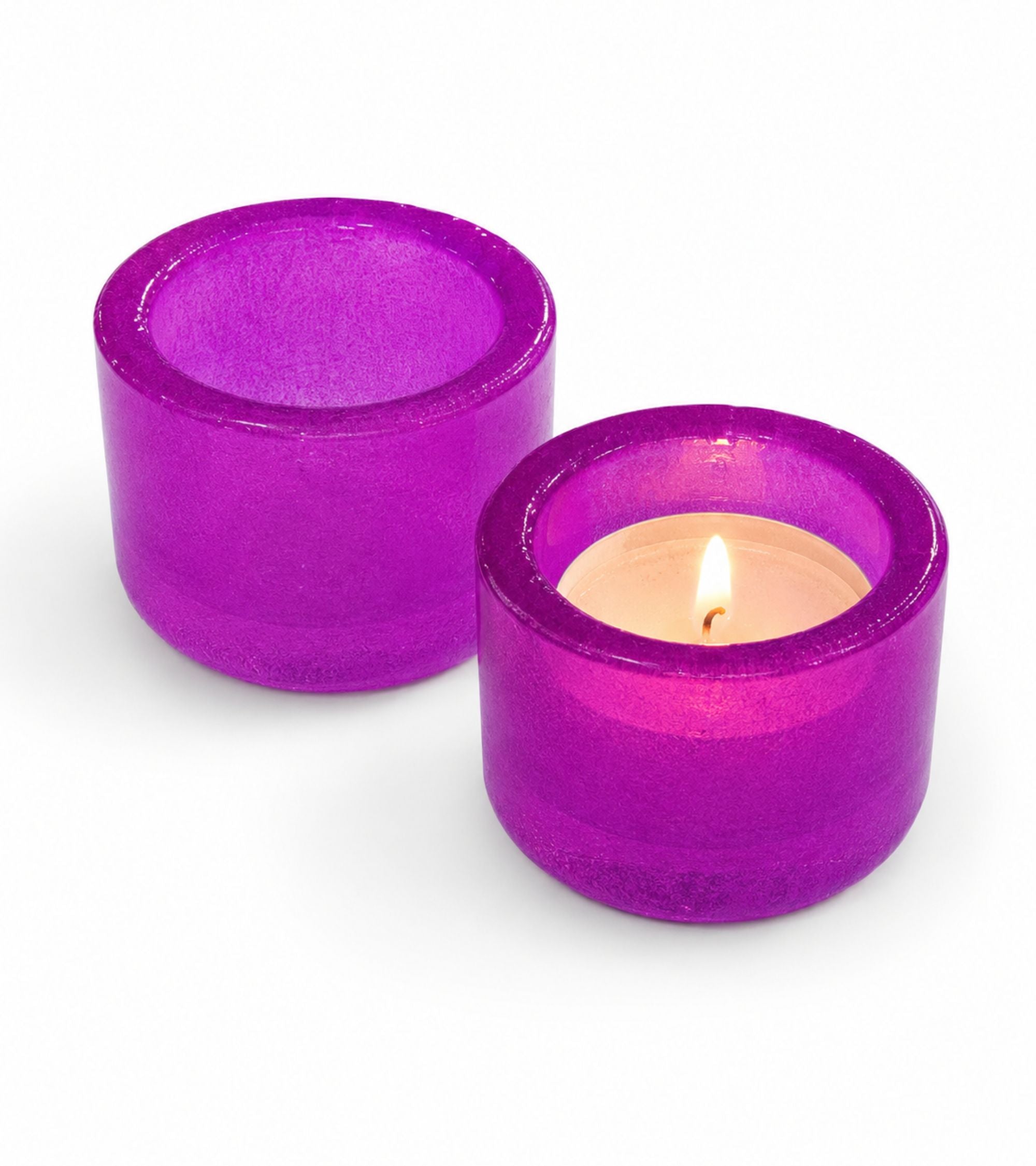 Purple glass votive candle holder with lit tealight inside