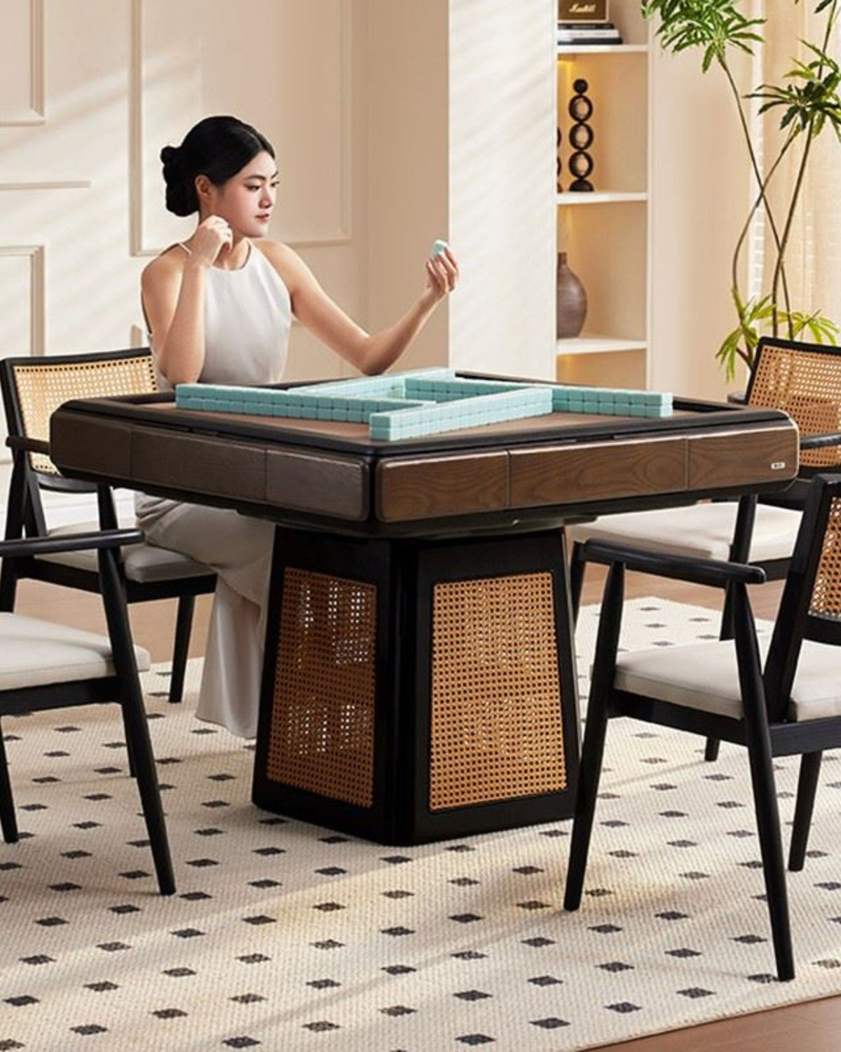 Mahjong table and chairs with woven wicker side panels, tiles on playing surface