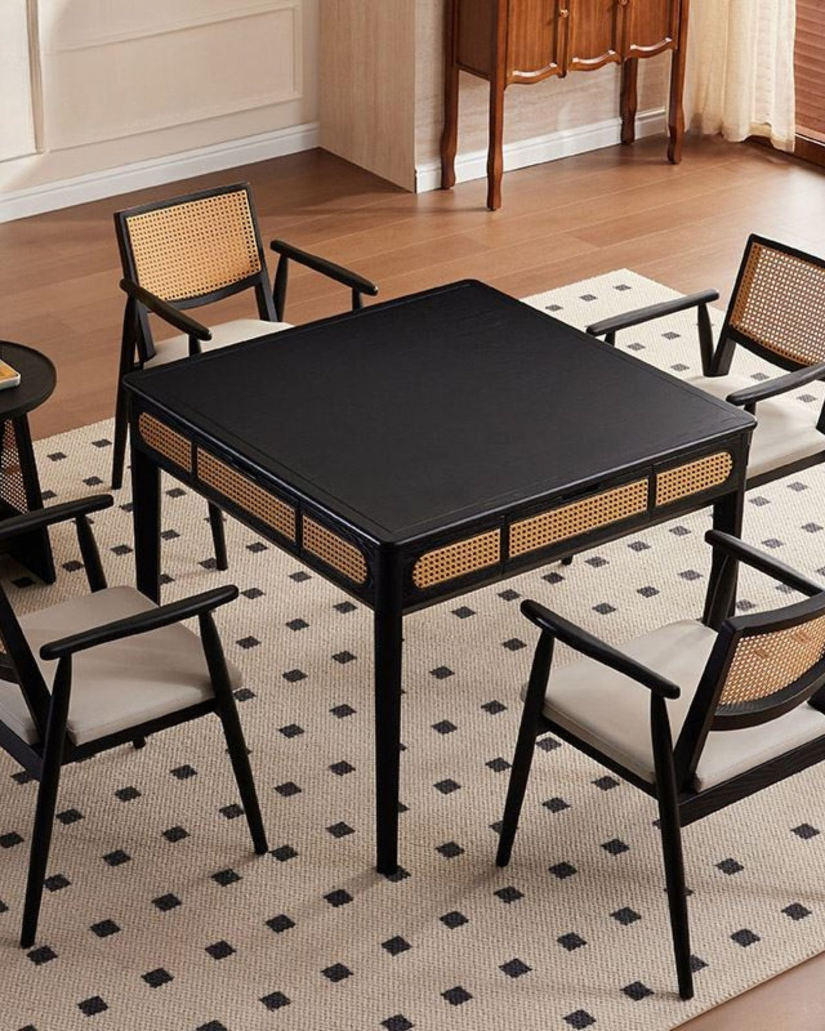 Black mahjong game table with perforated sides and four wicker chairs