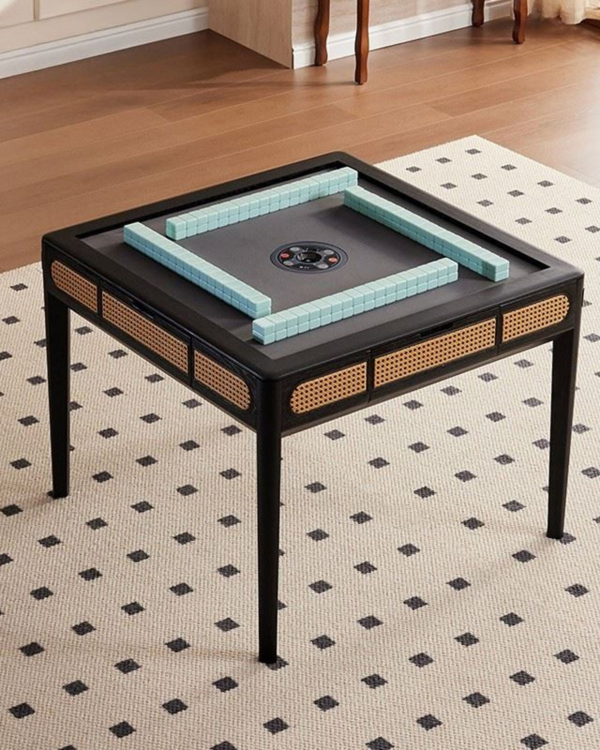 Mahjong game table with blue tile-lined center and four black wicker chairs