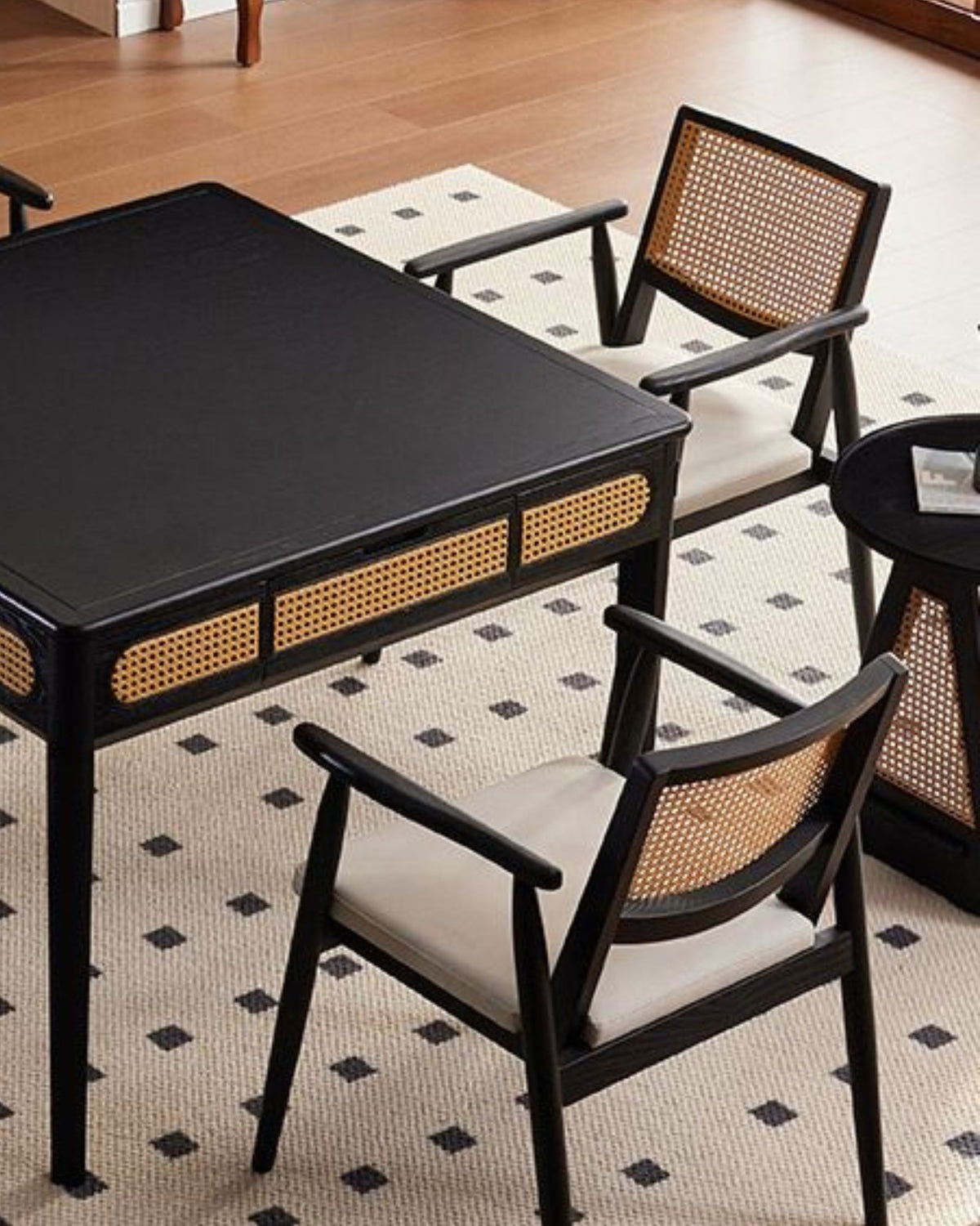 Black mahjong game table with perforated panel and matching wicker dining chairs