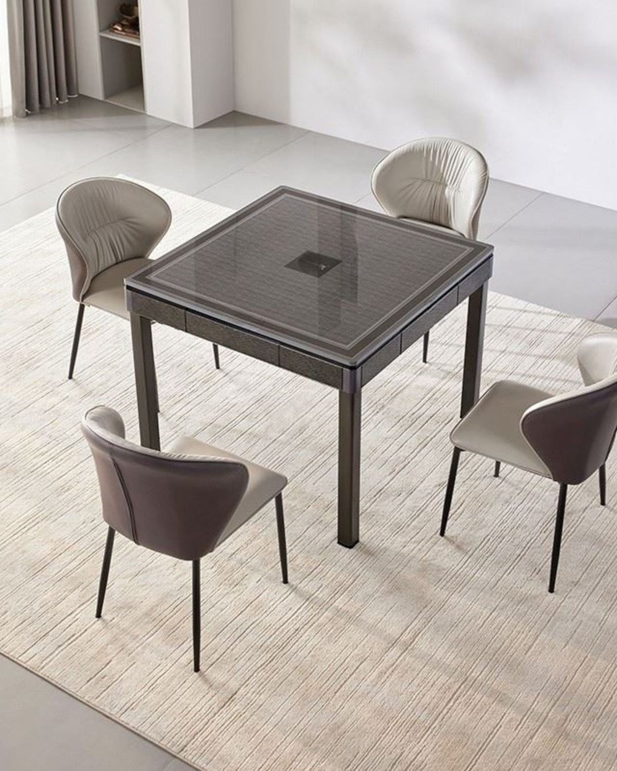 Black foldable mahjong table with grey top, surrounded by four upholstered chairs