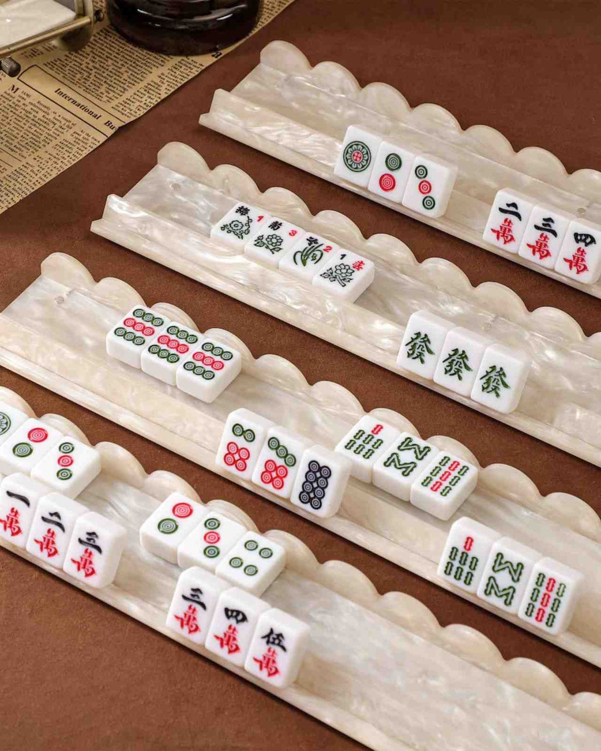 Pearl acrylic mahjong racks set of 4 lined up with scalloped holders and tiles