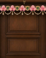 Floral toran wall hanging with pink flowers, pearl beads, and gold accents