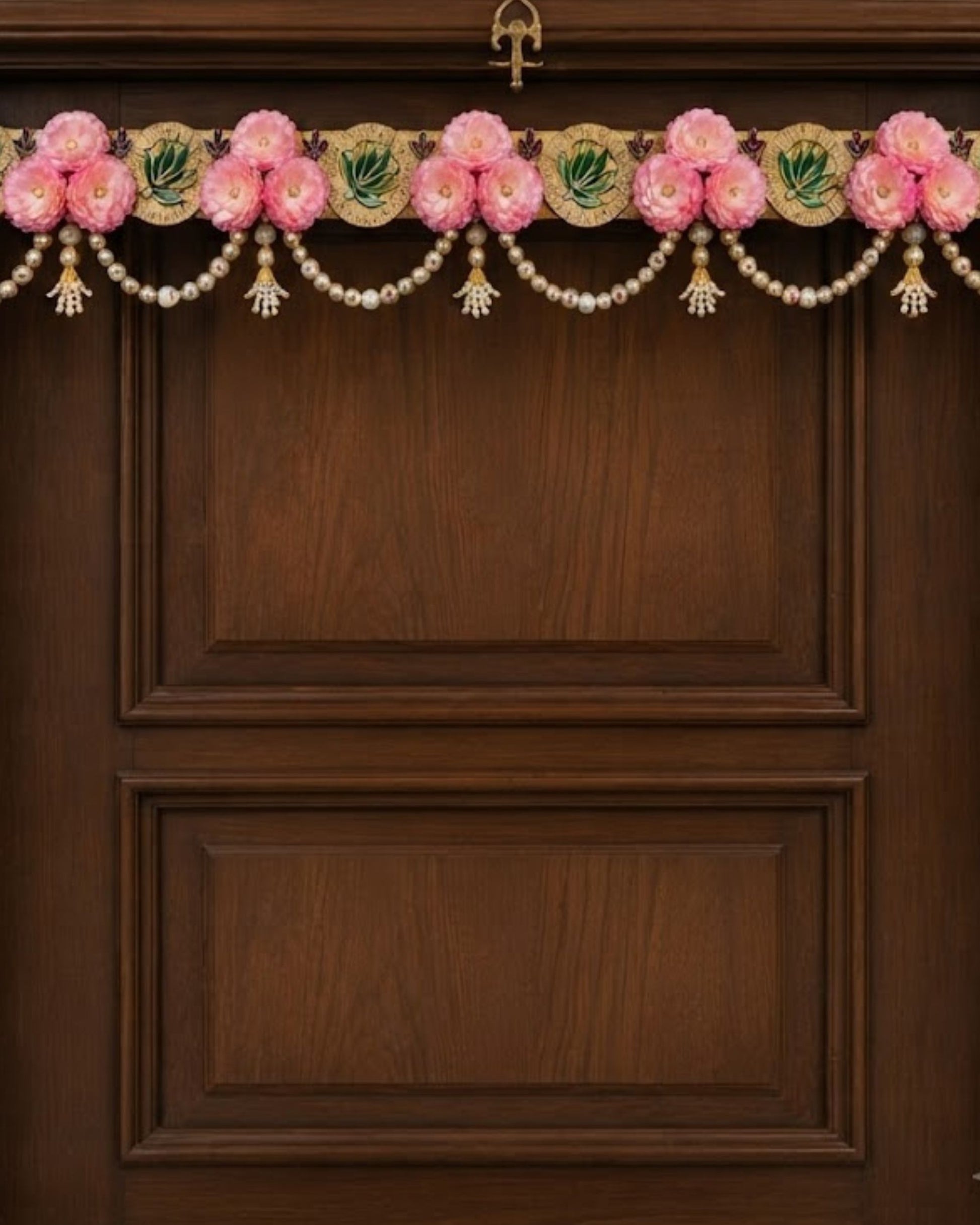 Floral toran wall hanging with pink flowers, pearl beads, and gold accents