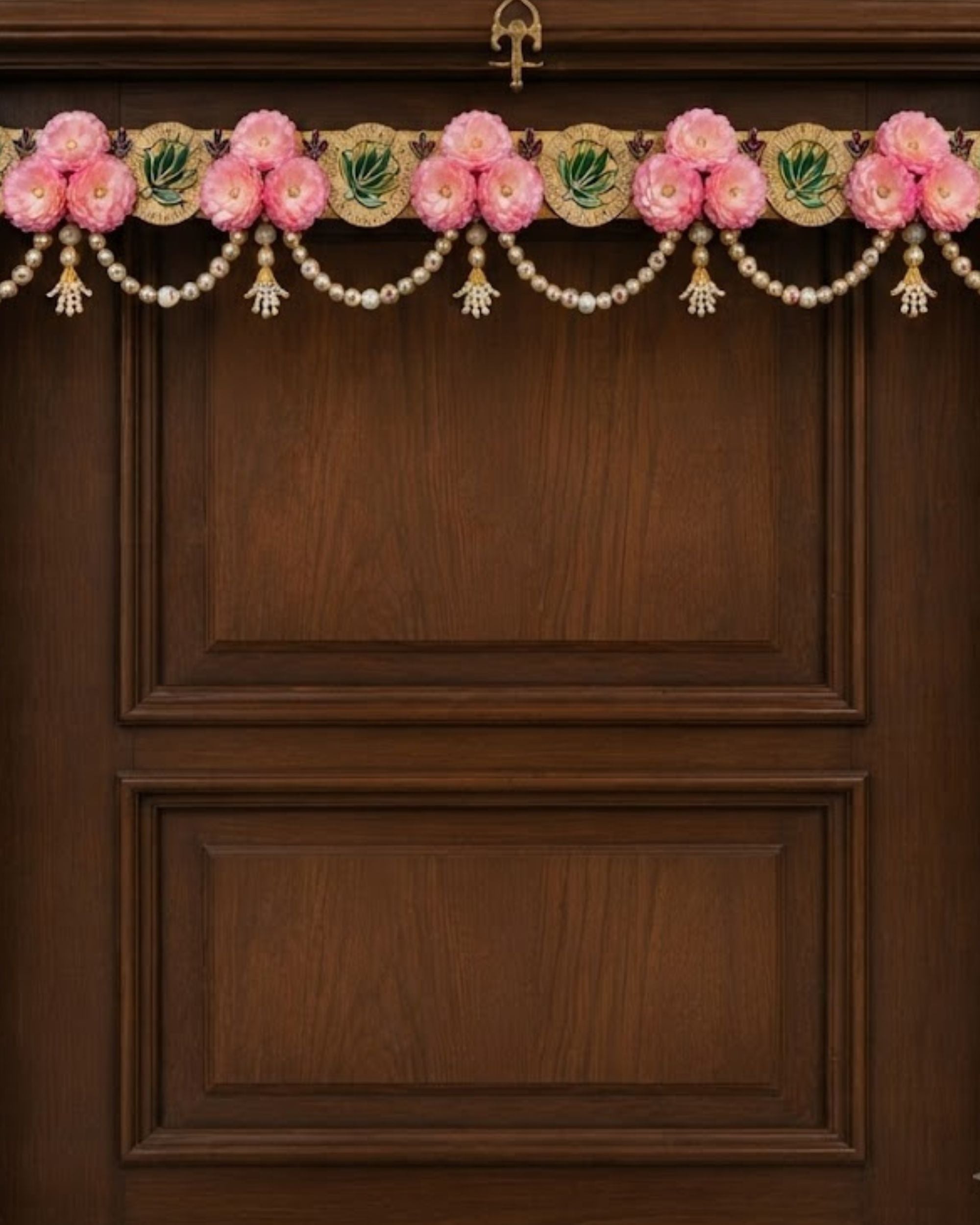 Floral toran wall hanging with pink flowers, pearl beads, and gold accents