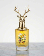 Floral perfume bottle with golden deer antler cap and amber glass