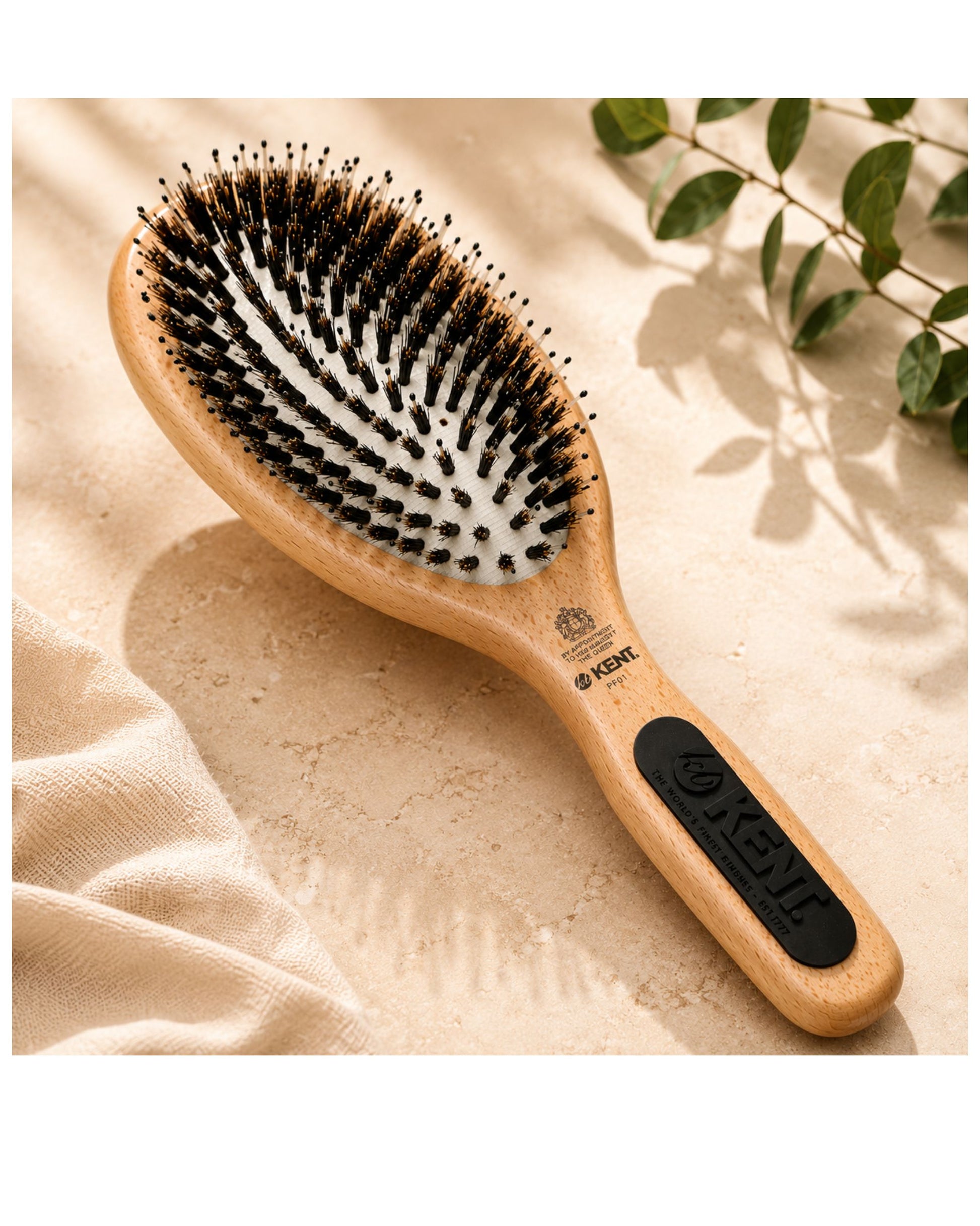 Beechwood cushion hair brush with natural bristles, black control label on handle.