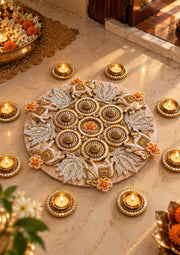 Beige round Diwali rangoli with floral motifs and lit tea light diyas