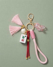 Pink bow mahjong keychain with tassel, pink cord, and small tile charm