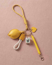 Lemon-yellow mahjong keychain with fabric pouch, tile charm, and metal key ring