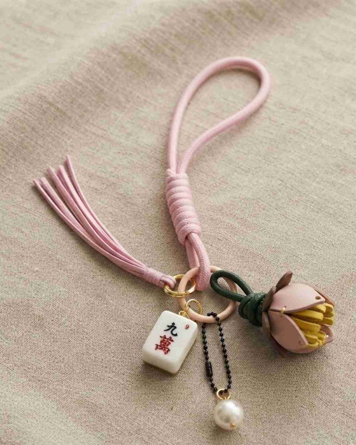 Pink mahjong keychain with flower-leaf charm, braided cord tassel and pearl dangle