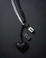 Black heart keychain charm with dangling metal piece and white mahjong tile