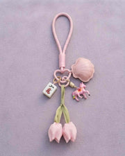 Pink tulip mahjong keychain with fabric loop and charms, including a red character tile