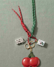 Mahjong cherry keychain with two red cherry charms, mini tile pieces, braided cords.