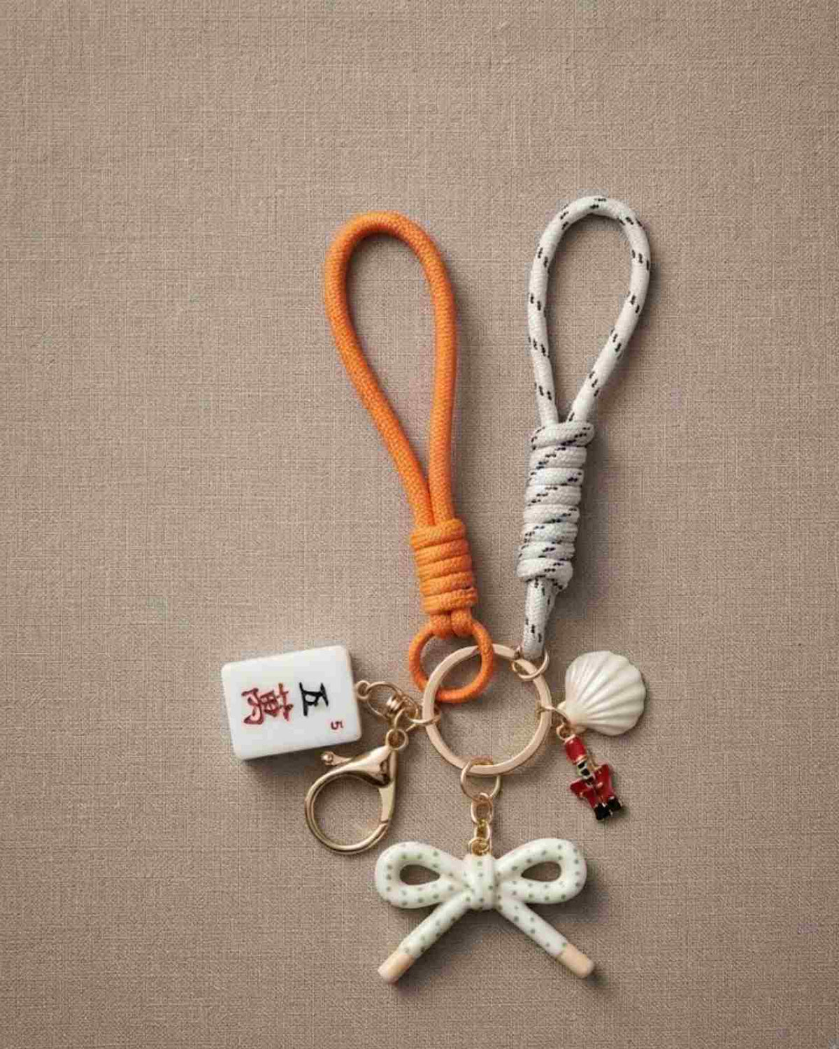 White mahjong keychain with patterned loop, white bow charm, shell tassel