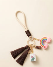 Mahjong keychain with rainbow charm, brown tassels, and small tile pendant
