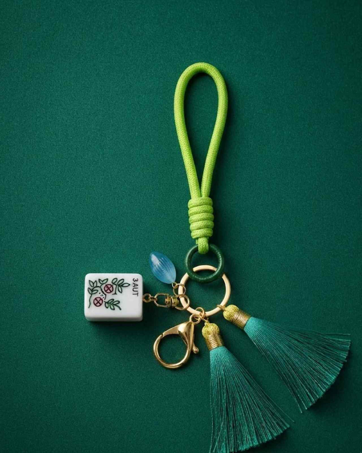 Premsons® green mahjong keychain with white charm, gold keyring, and green tassel cord