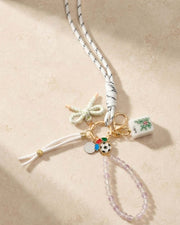 Multicolor tassel keychain with gold ring and small charm tile and soccer ball