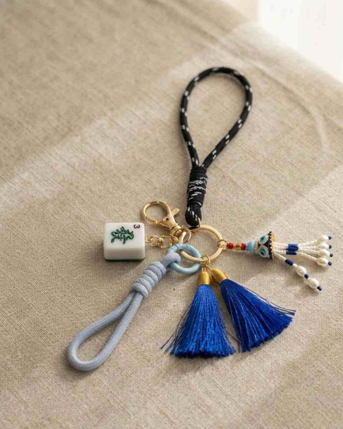 Premsons® Mahjong keychain with blue tassel, beaded accents, and braided strap