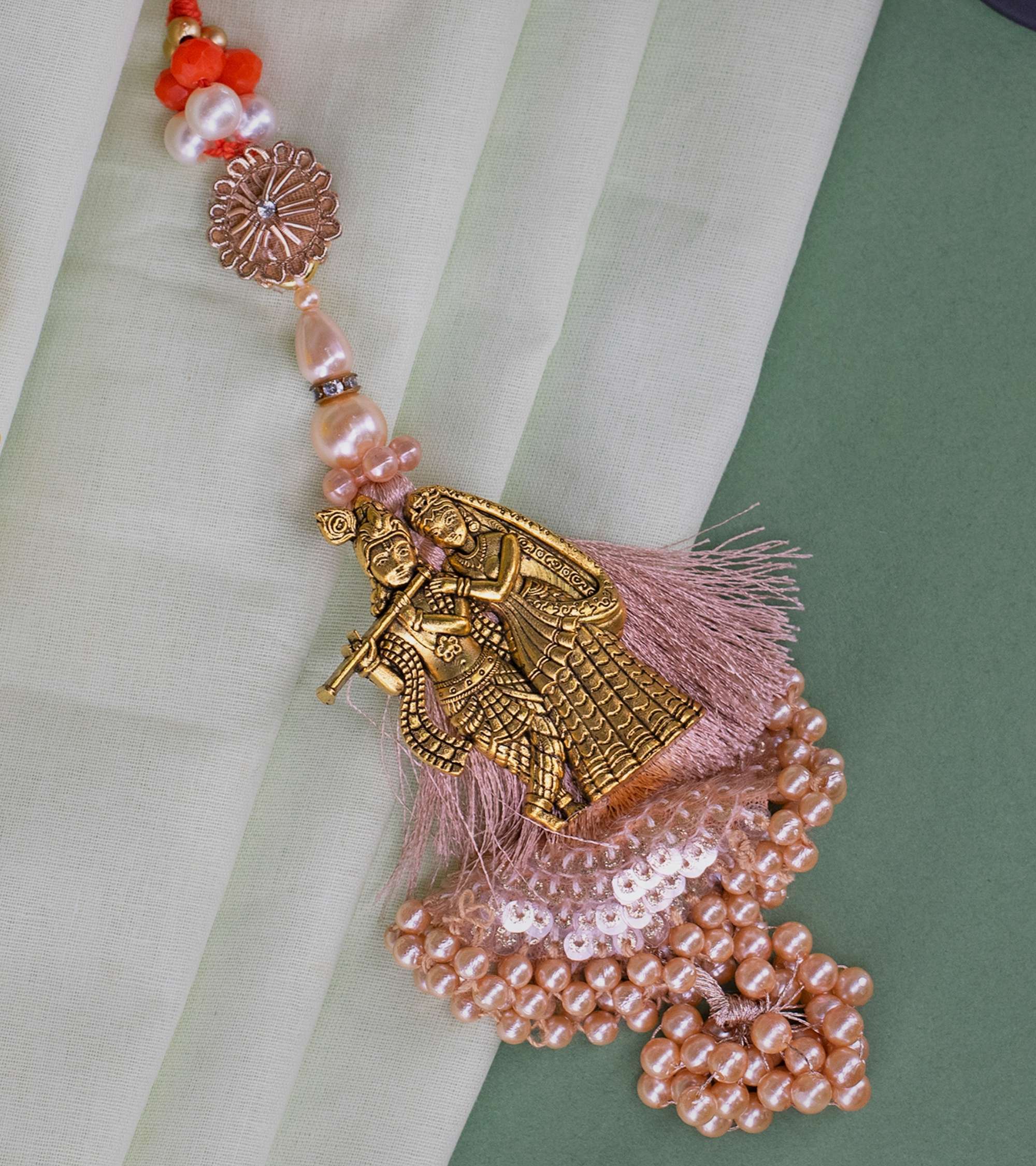 Premsons® Divine Grace Lumba Rakhi – Radha Krishna in Gold with Pearl Tassels