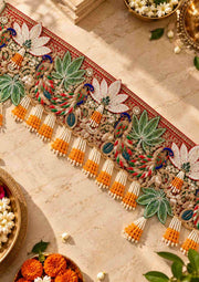 Festive decorative toran with colorful floral motifs and bead tassels along the border