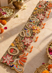 Decorative Ganeshji toran with beadwork, floral motifs, and orange tassels for door