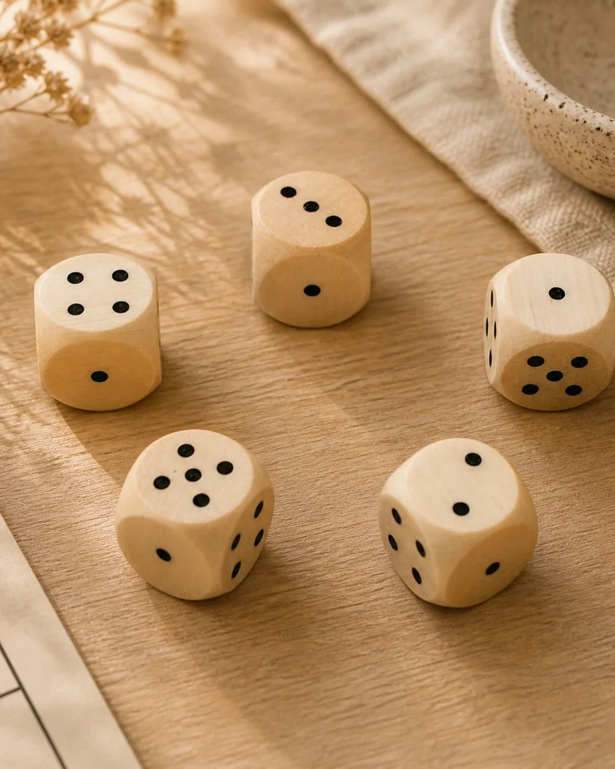 Natural wooden game dice with dot faces on a tabletop