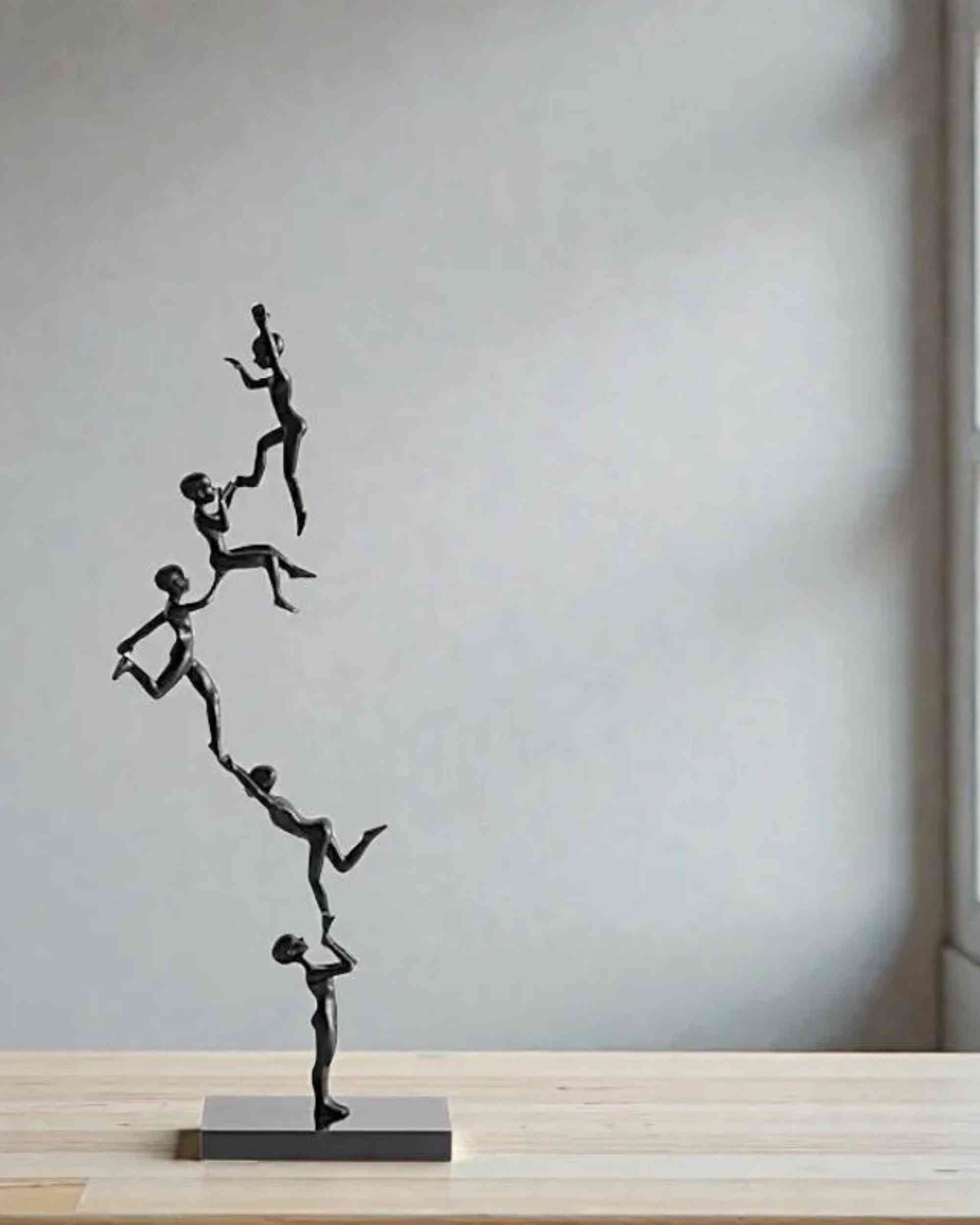 Black standing branch sculpture figurines, displayed on rectangular marble base
