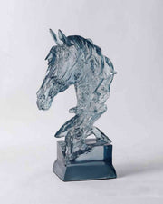 Ice blue resin horse figurine sculpture on a dark base, side profile