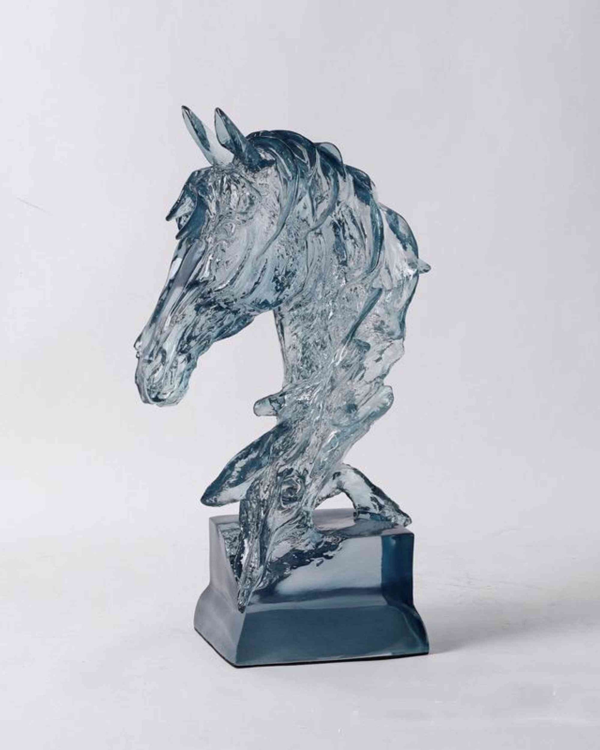 Ice blue resin horse figurine sculpture on a dark base, side profile