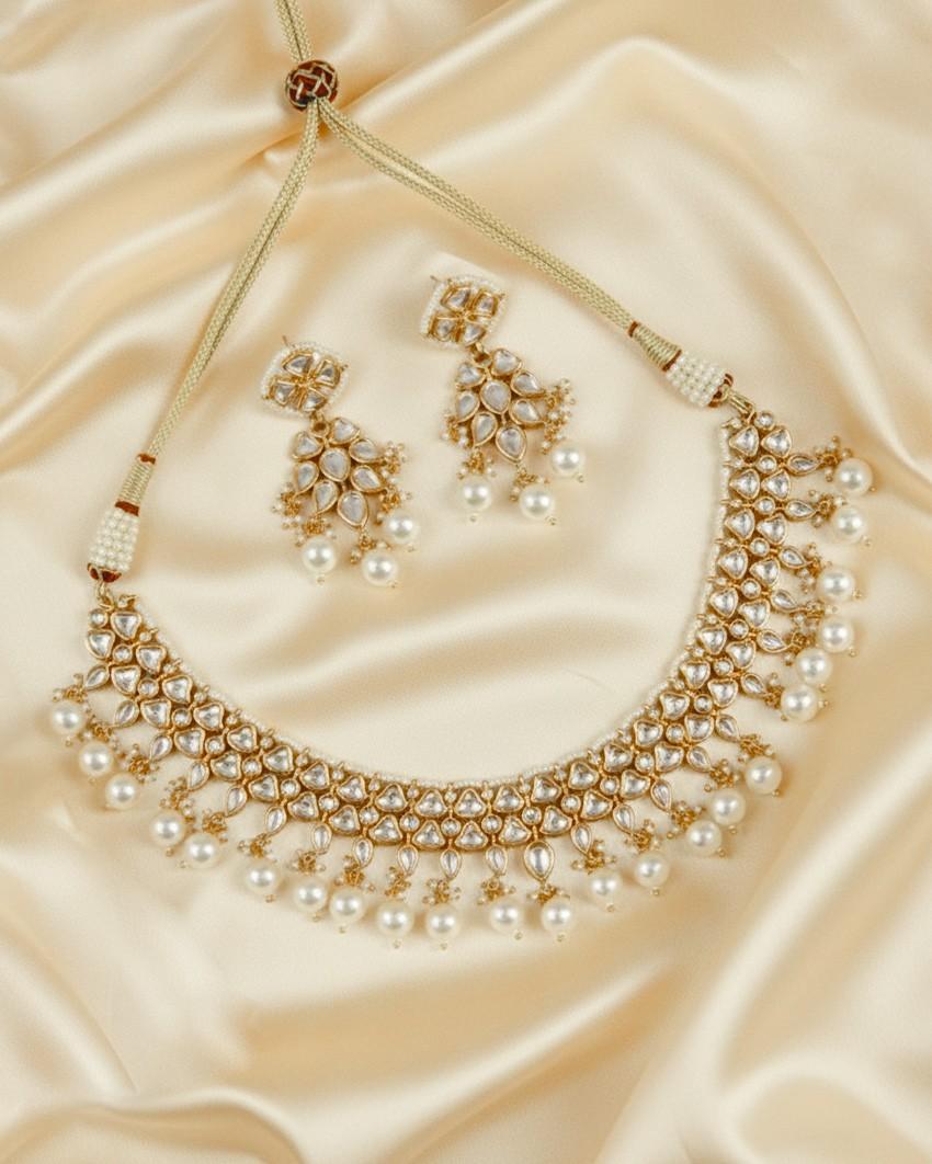Gold kundan necklace set with pearl fringe and matching kundan stud earrings