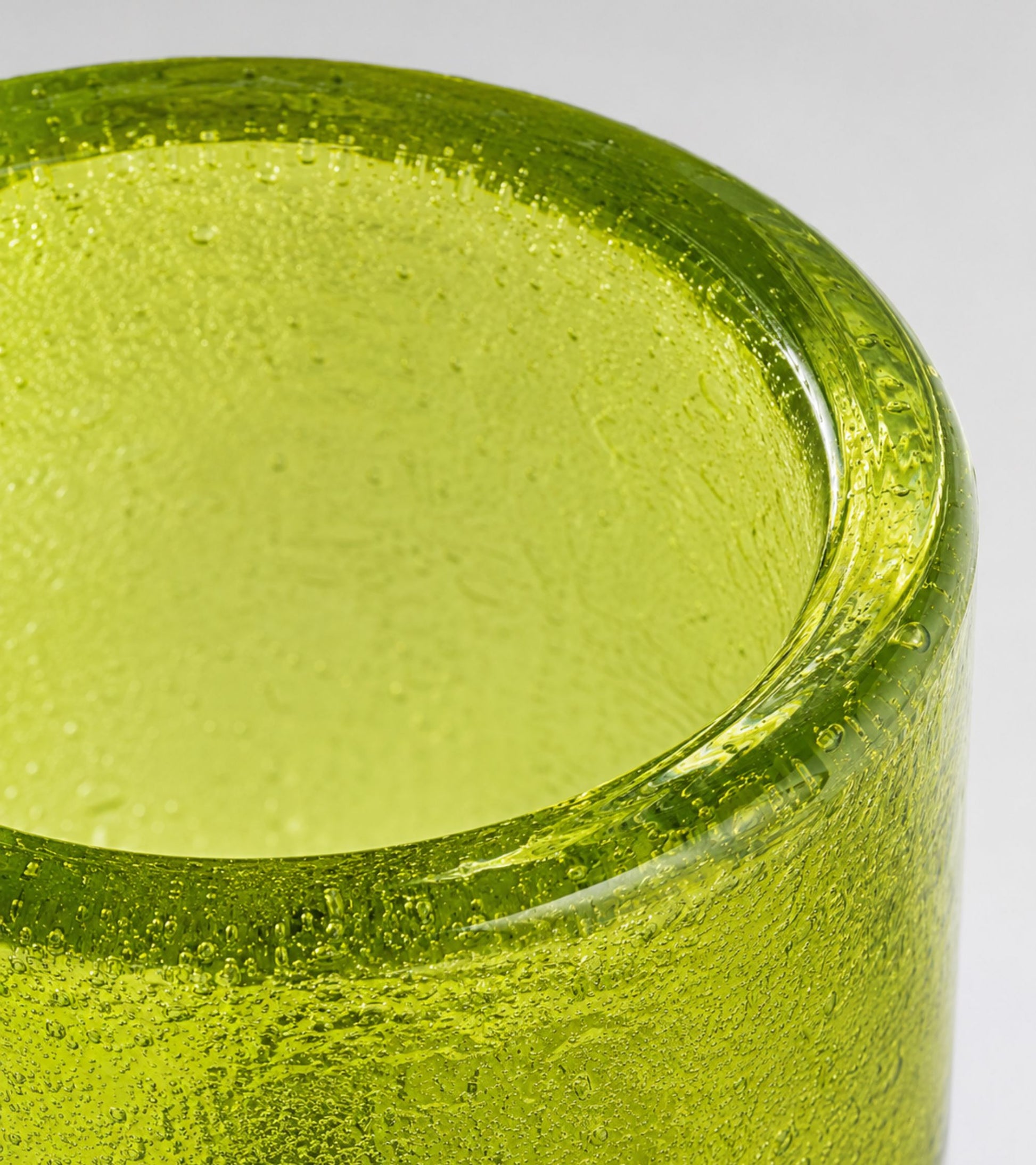 Green glass votive candle holder with round open top