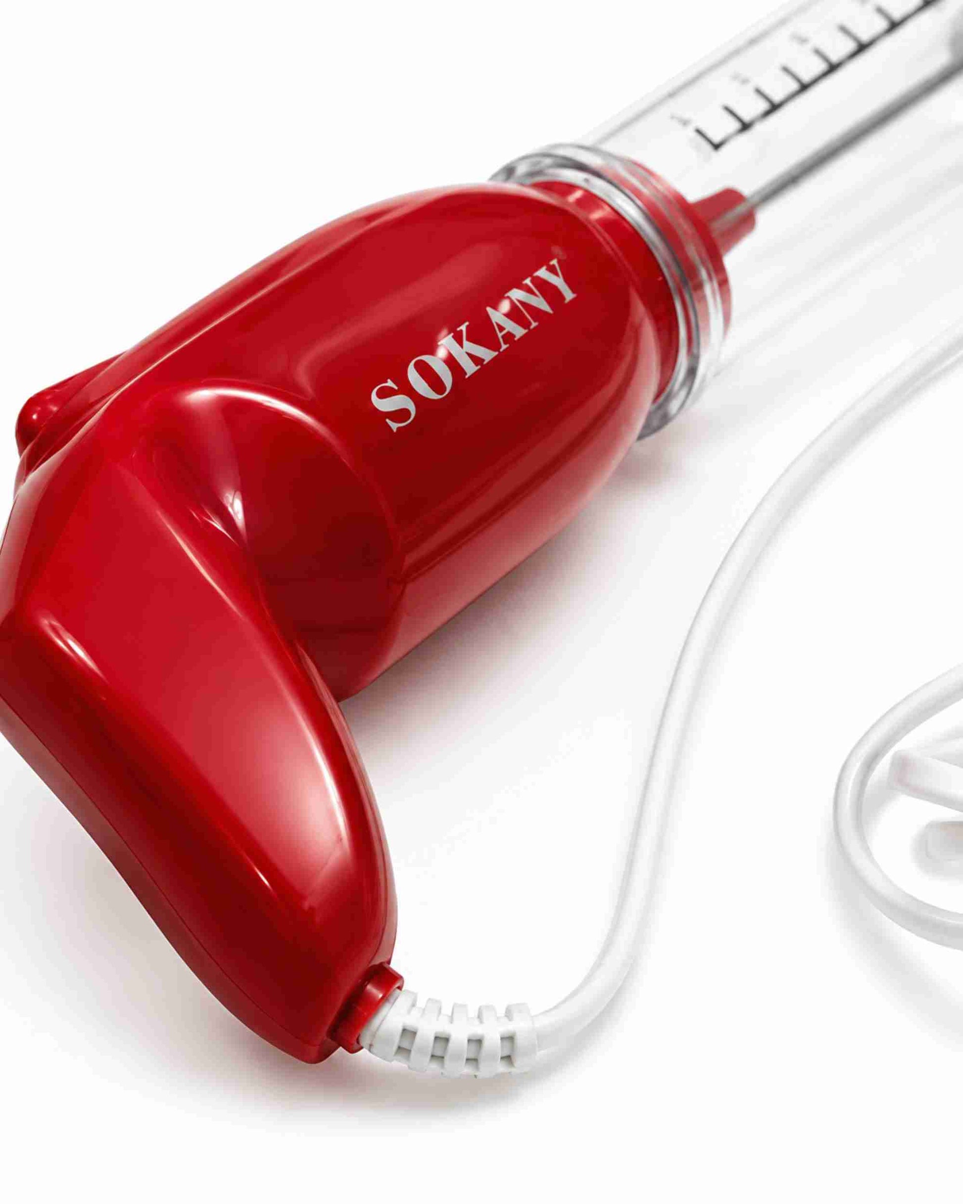 Close-up of red electric coffee blender head with clear mixing tube and cord