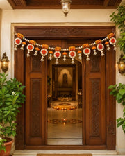 Handmade floral toran garland with orange marigold beads, white pearls, and round ornaments