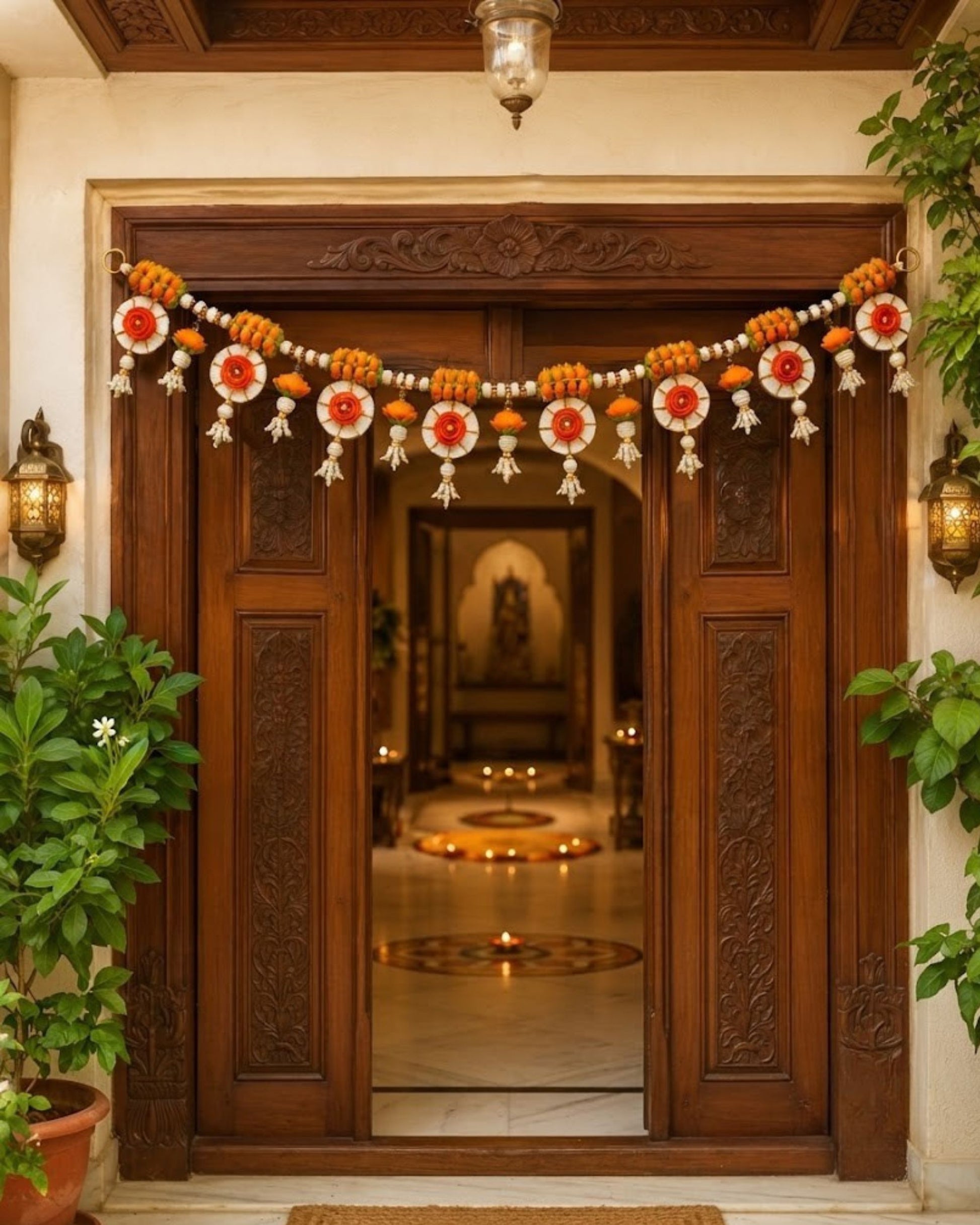 Handmade floral toran garland with orange marigold beads, white pearls, and round ornaments