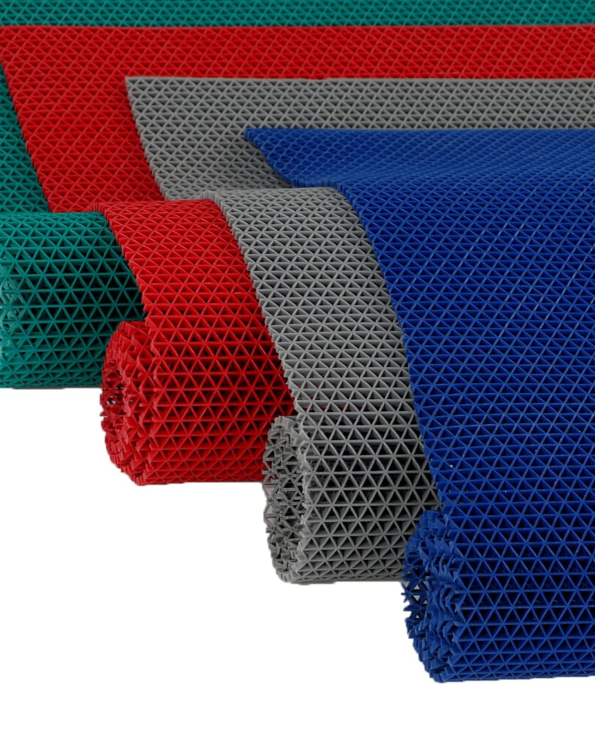 Assorted anti-skid floor mats in blue, gray, red, and green with textured grid