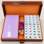 Lavender mahjong tile set in open box with animal and symbol tile faces