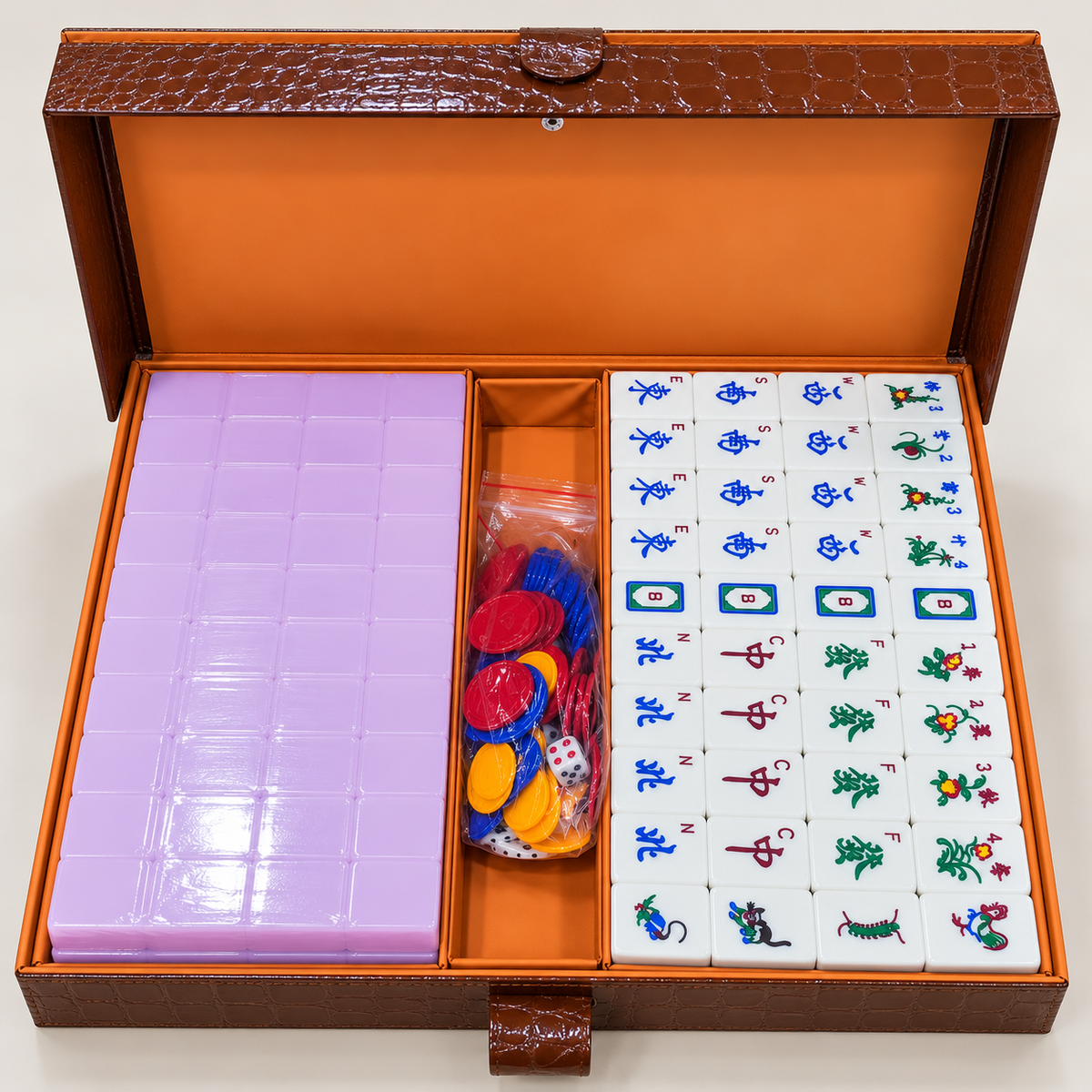 Lavender mahjong tile set in open box with animal and symbol tile faces