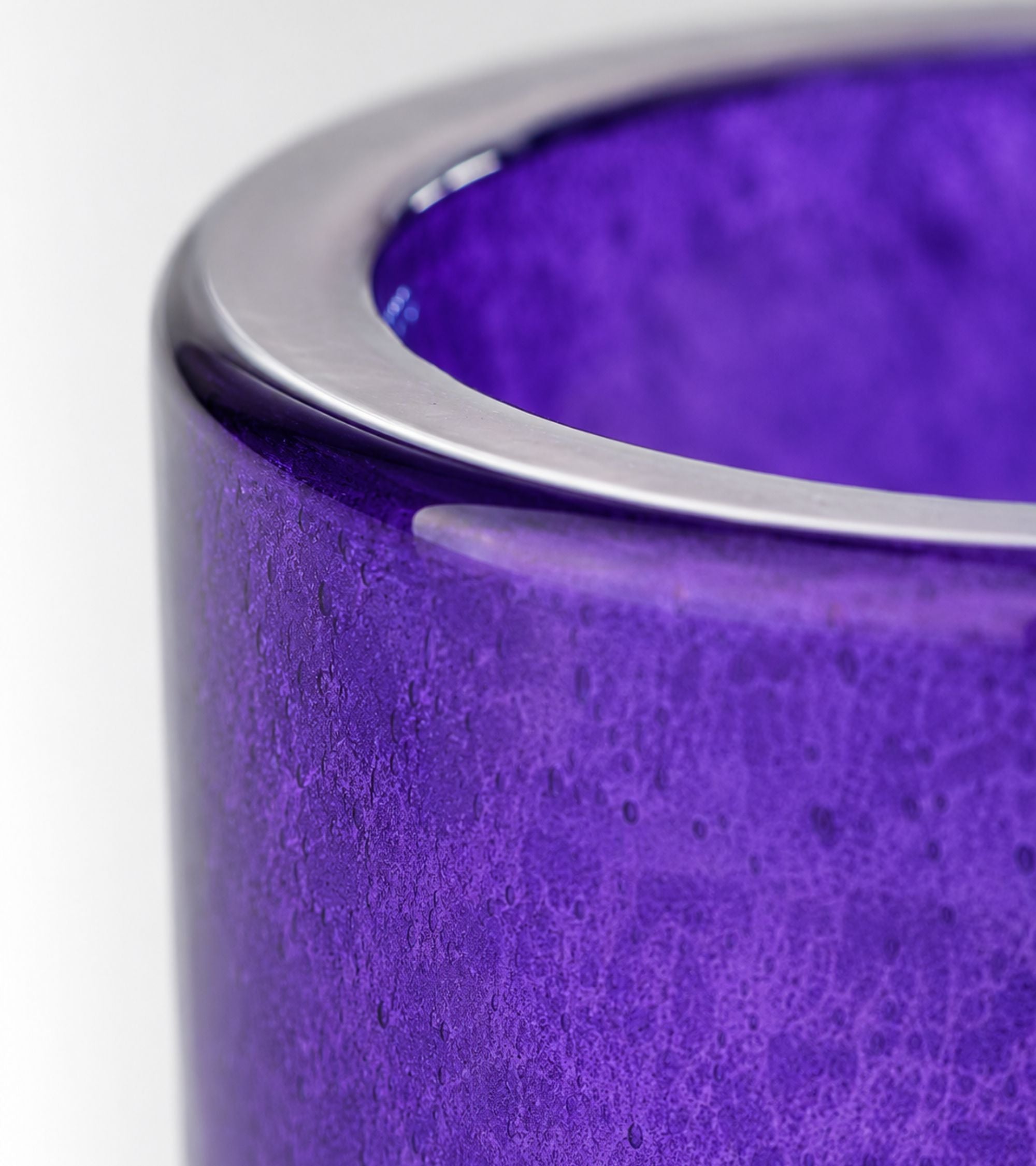Purple glass votive candle holder, close-up of rim